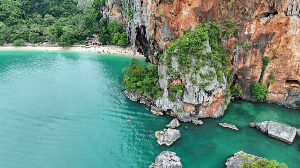 Aerial view of Railay Beach in Krabi, with limestone cliffs rising above turquoise water
